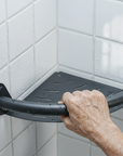 Luxworth corner shower caddy with integrated grab bar, showcasing a sleek shower shelf and safety grab rail in a modern bathroom setting.