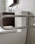 Stainless steel folding grab rail by Luxworth, mounted on a wall, designed for safety and support in bathrooms or near stairs.