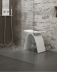 Luxworth stone arched shower stool with a solid surface, designed for bathroom seating and support.