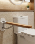 Foldable wooden and satin aluminium toilet grab rail by Luxworth, designed for safety and support in the bathroom.