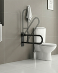 Folding Luxworth toilet grab rail mounted beside a toilet for added safety and support, with the rail folded up against the wall.