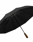 Luxworth compact travel umbrella open, lightweight and portable with a sleek black canopy and sturdy handle.