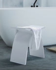 Luxworth stone arched shower stool with solid surface seat and sturdy legs, designed for bathroom seating and support.