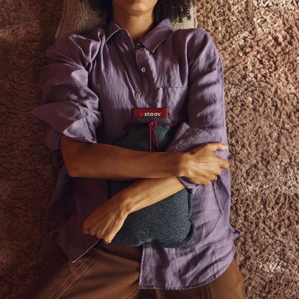 Luxworth Stoov Homey³ Original infrared heating pad with digital controls and soft fabric cover, shown in a cozy setting.